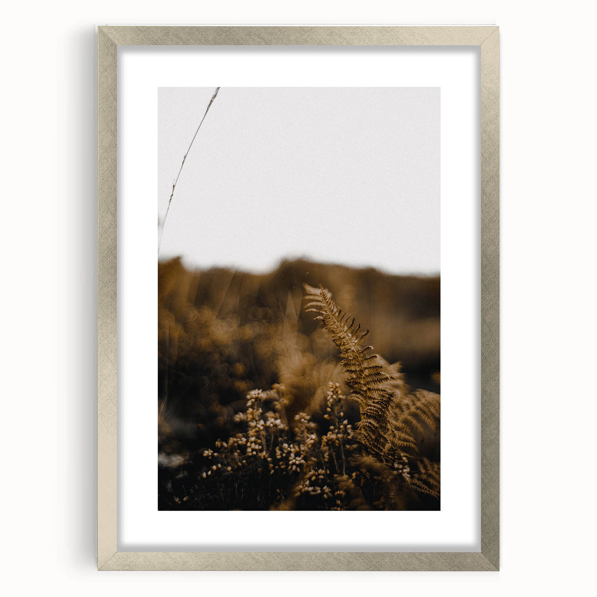 Textured abstract art print depicting autumnal shades in a silver frame, suitable for bedroom wall decor.