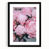 Abstract art print featuring vibrant spring hues on textured canvas, framed in black, ideal for living room decor.