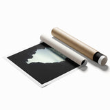 A beautifully rolled print of a colorful landscape scene featuring caves, showcasing intricate details and vibrant colors, packaged securely in a protective cardboard tube.