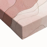 Close-up of a stretched canvas showcasing an abstract landscape design in vibrant colors, featuring bold brush strokes and intricate textures that enhance modern decor.