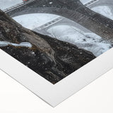 Rolled canvas artwork showcasing a serene landscape bridge scene, highlighted by vibrant colors and intricate details, securely packaged in a protective cardboard tube.