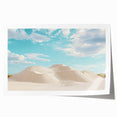 Desert landscape rolled canvas print showcasing vibrant hues of orange and yellow against a serene blue sky, elegantly packaged in a protective cardboard tube, ideal for home decor.