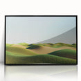 Framed acrylic artwork depicting a serene landscape of rolling green fields under a blue sky, with a sleek black frame enhancing its modern aesthetic. Perfect for home decor.