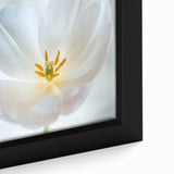 Close-up of a black framed canvas featuring a colorful floral design with textured details, ideal for living room decor.