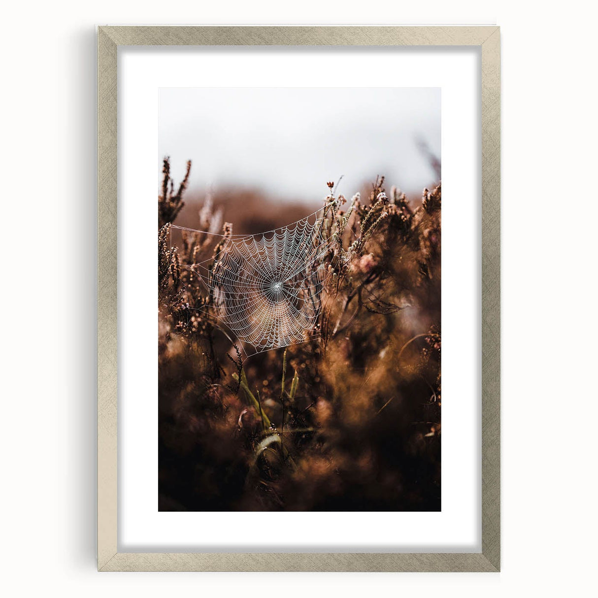 Textured abstract art print depicting fall colors in orange and brown on a silver-framed canvas, suitable for bedroom decor.