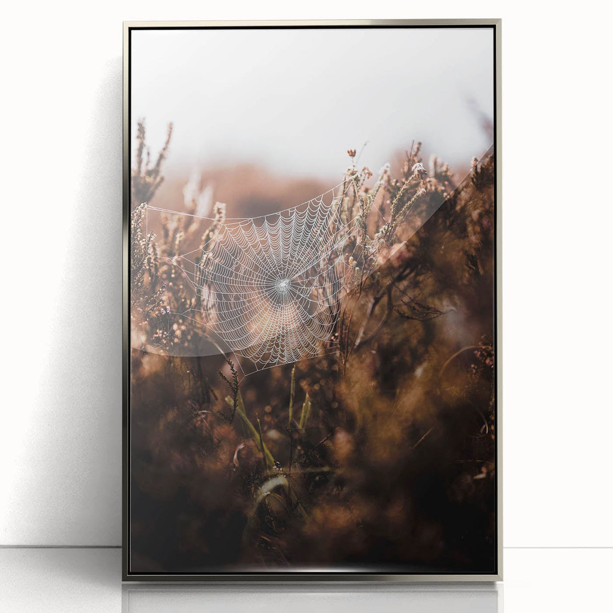 Mid-century modernist art depicting autumn trees in orange and yellow tones on a silver-framed acrylic print.