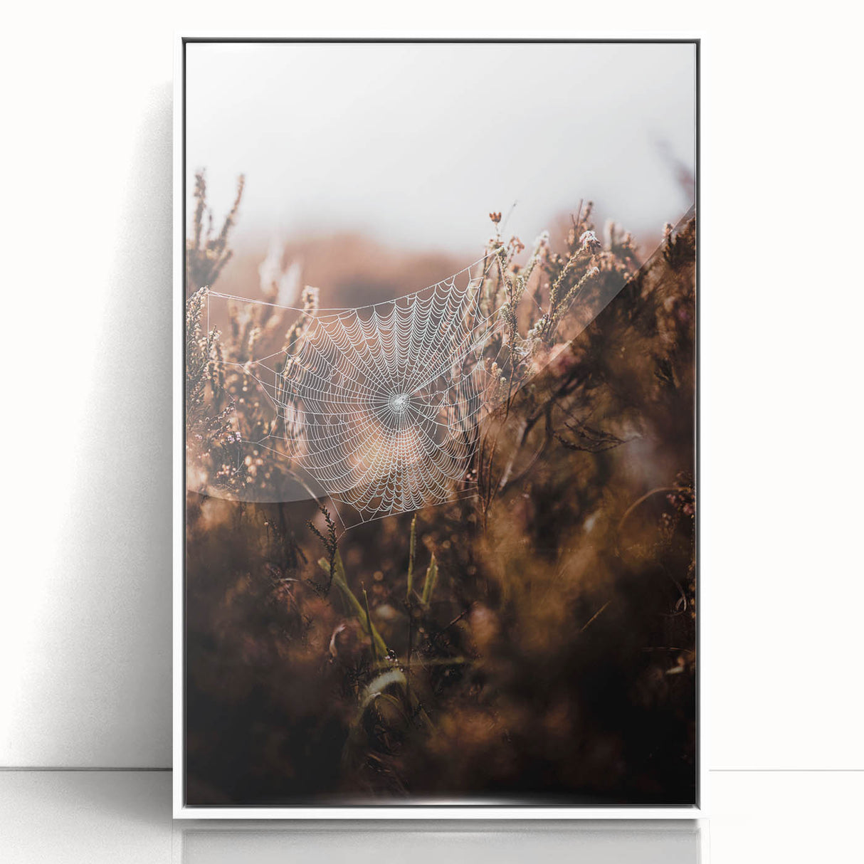 Art deco poster featuring an autumnal scene with warm orange and brown tones on a white framed acrylic.