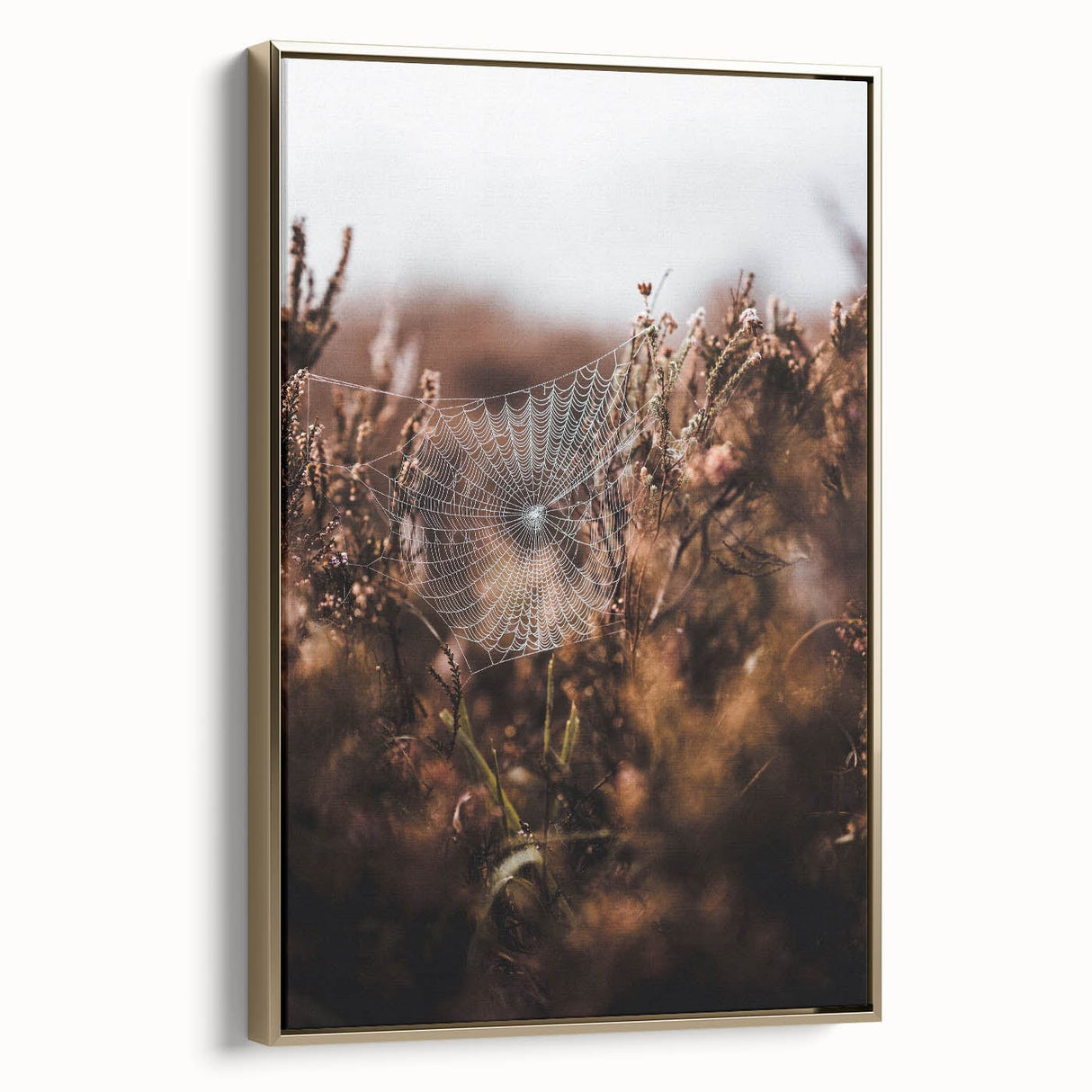 Framed canvas featuring a vintage poster art style landscape painting with black and gold tones.