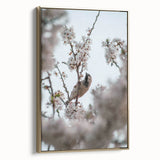 Framed canvas featuring a vintage poster-style landscape painting with spring motifs in gold and black.