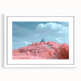 Framed landscape artwork showcasing a picturesque castle surrounded by lush greenery, presented in a white mat for an elegant finish, perfect for home decor.