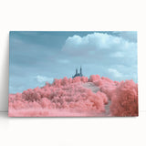 Stretched canvas artwork depicting a scenic landscape with a majestic castle surrounded by lush greenery, ideal for enhancing home decor or office spaces.