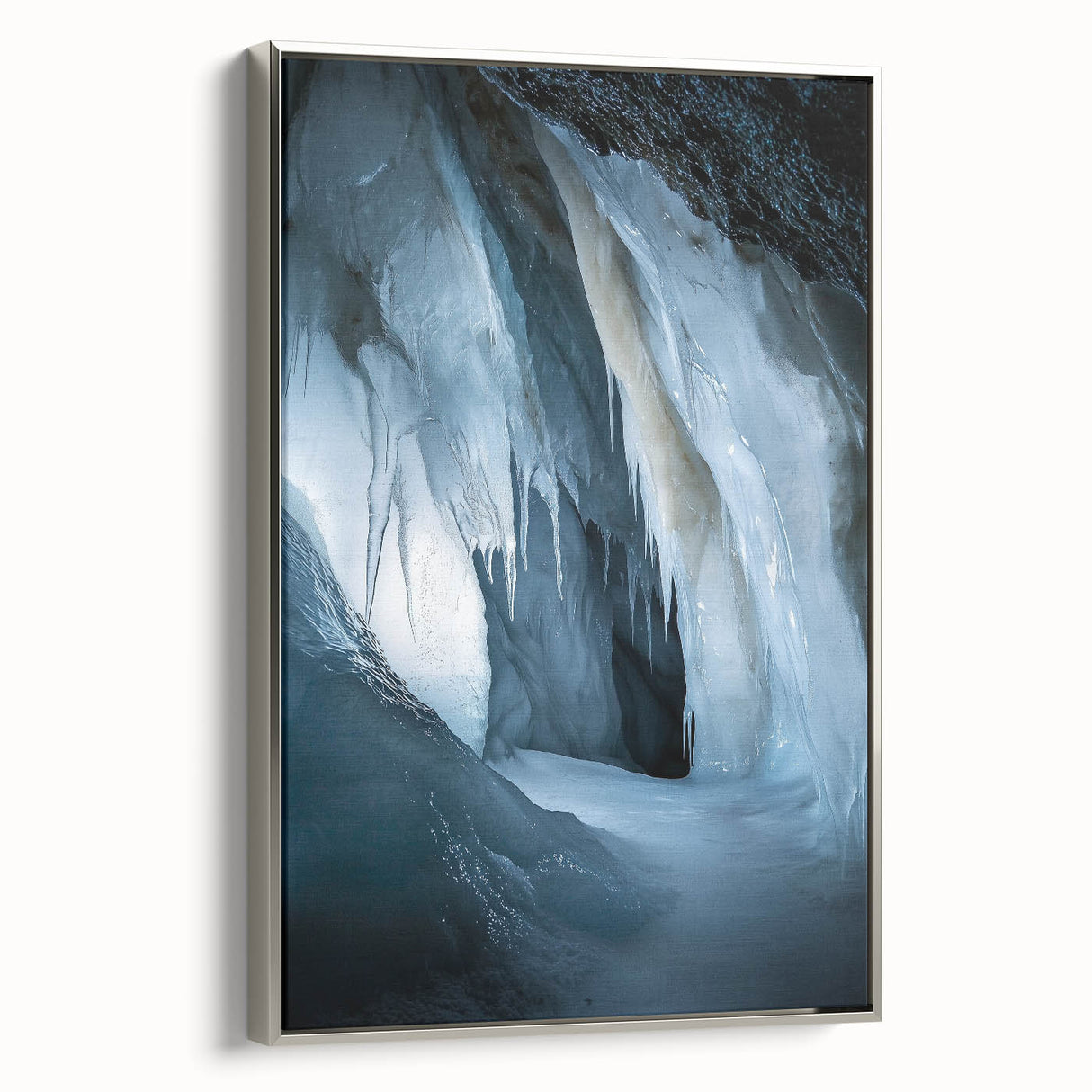 Framed canvas artwork showcasing a stunning landscape of caves, with a silver frame highlighting the intricate details and natural colors, perfect for home decor.