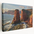 Stretched canvas artwork depicting a stunning landscape of cliffs under a vibrant sunset, showcasing rich colors and intricate details, perfect for home decor.