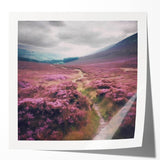 Landscape wall art print showcasing a serene countryside scene with rolling hills and vibrant green fields, presented in a glossy finish. Ideal for home decor.