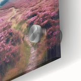 Close-up of a vibrant landscape wall art piece showcasing rolling green hills and a serene countryside scene, printed on acrylic glass for a modern touch.