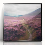 Framed acrylic wall art depicting a serene countryside landscape with vibrant green fields and a clear blue sky, enclosed in a sleek black frame, perfect for home decor.