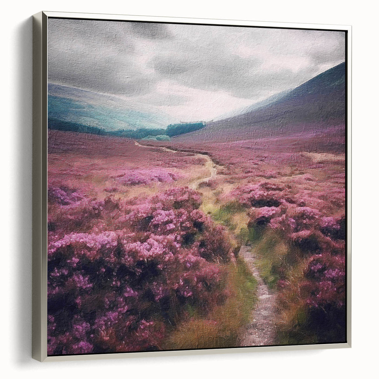 Framed canvas wall art depicting a serene countryside landscape with rolling hills and vibrant greenery, showcasing a silver frame from a side view. Perfect for enhancing home decor.