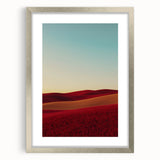 Elegant silver-framed landscape artwork depicting serene countryside scenery, featuring lush green fields and a vibrant blue sky, perfect for home decor.
