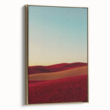 Framed canvas artwork depicting a serene countryside landscape with vibrant greens and soft gold accents, elegantly displayed from a side view.