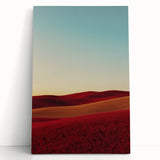 Stretched canvas art depicting a serene countryside landscape, featuring rolling green hills, a bright blue sky, and soft white clouds, perfect for home decor.