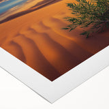 Desert landscape rolled canvas featuring warm tones of orange and yellow with rugged mountains and a clear blue sky, ideal for home decor or art collections.