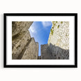Framed landscape artwork featuring a picturesque castle scene, enclosed in a sleek black frame with a white mat, perfect for home decor and wall art enthusiasts.
