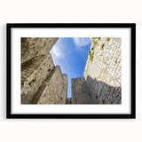 Framed landscape artwork featuring a picturesque castle scene, enclosed in a sleek black frame with a white mat, perfect for home decor and wall art enthusiasts.