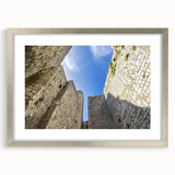 Elegant silver-framed landscape artwork depicting a picturesque castle surrounded by lush greenery, enhanced with a white mat for a refined look, perfect for home decor.