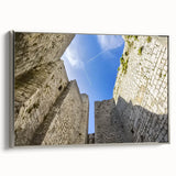 Framed canvas artwork showcasing a scenic landscape with a majestic castle, elegantly displayed with a silver frame, ideal for home decor enhancement.