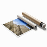 Rolled print showcasing a vibrant landscape of a majestic castle surrounded by lush greenery, elegantly packaged in a protective cardboard tube for easy display.