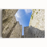 Stretched canvas art piece depicting a vibrant landscape with a majestic castle surrounded by greenery, showcasing intricate details and vivid colors for home decor.