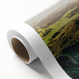 Stunning rolled canvas artwork showcasing a vibrant cliff landscape, featuring rich colors and intricate details, securely packaged in a protective cardboard tube for delivery.