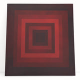 Abstract geometric canvas art in vibrant colors, elegantly leaning against a wall, showcasing unique shapes and modern design, perfect for contemporary home decor.