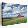 Stretched canvas artwork displaying a vibrant landscape scene of a rustic barn surrounded by lush greenery, perfect for home decor or art enthusiasts.