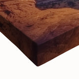 Close-up of a stretched canvas depicting a vibrant landscape of canyons, showcasing rich earthy tones and intricate details, perfect for home decor.