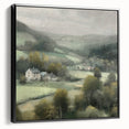 Framed landscape wall art depicting a serene countryside scene with vibrant green fields and a clear blue sky, showcased in a sleek black frame for modern decor.