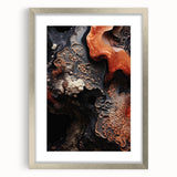 Textured art print of abstract natural elements in muted earth tones, framed in silver, ideal for bedroom ambiance.