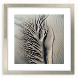 Textured art print featuring abstract nature elements in muted green and brown tones, framed in silver.
