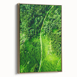 Framed canvas depicting a spring landscape with lush greenery and blooming trees, ideal for bedroom wall art.