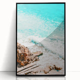 Large abstract wall art print in vibrant orange and yellow tones on acrylic, framed in black.