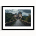 Black-framed landscape artwork depicting a majestic castle surrounded by lush greenery, with a white mat enhancing its elegance, perfect for home decor.