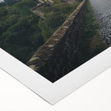 Rolled canvas artwork depicting a vibrant landscape with a majestic castle, showcasing rich colors and intricate details, ideal for enhancing home decor.