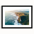 Black-framed landscape artwork showcasing rugged cliffs and serene skies, highlighted with a white mat, ideal for modern home decor and nature enthusiasts.
