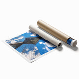 Rolled art print showcasing a stunning landscape bridge scene, featuring vibrant colors and intricate details, securely packaged for safe delivery in a cardboard tube.