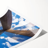 Rolled print of a landscape bridge design showcasing intricate details and vibrant colors, packaged securely in a cardboard tube for easy transport and protection.