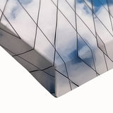 Close-up of a stretched canvas artwork depicting a serene landscape with a bridge, showcasing vibrant colors and intricate details, perfect for home decor or art enthusiasts.