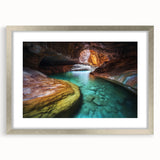 Silver-framed landscape artwork depicting majestic canyons, featuring a mat for added elegance. Ideal for home decor, bringing nature's beauty indoors.