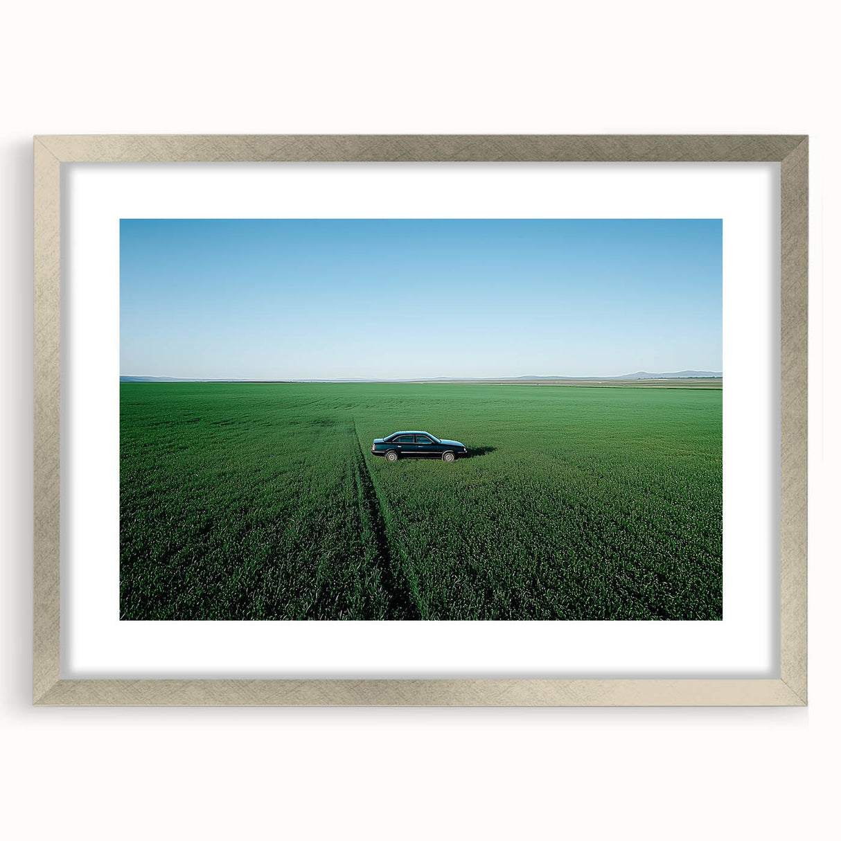 Framed silver landscape artwork depicting a serene countryside scene, featuring rolling hills and a clear blue sky, perfect for home decor enhancement.