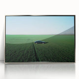 Framed acrylic artwork showcasing a serene countryside landscape with vibrant green fields and a clear blue sky, elegantly mounted in a silver frame for home decor enhancement.