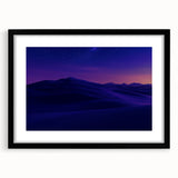 Framed landscape artwork depicting a serene desert scene, featuring warm tones and intricate details, presented in a stylish black mat and frame.